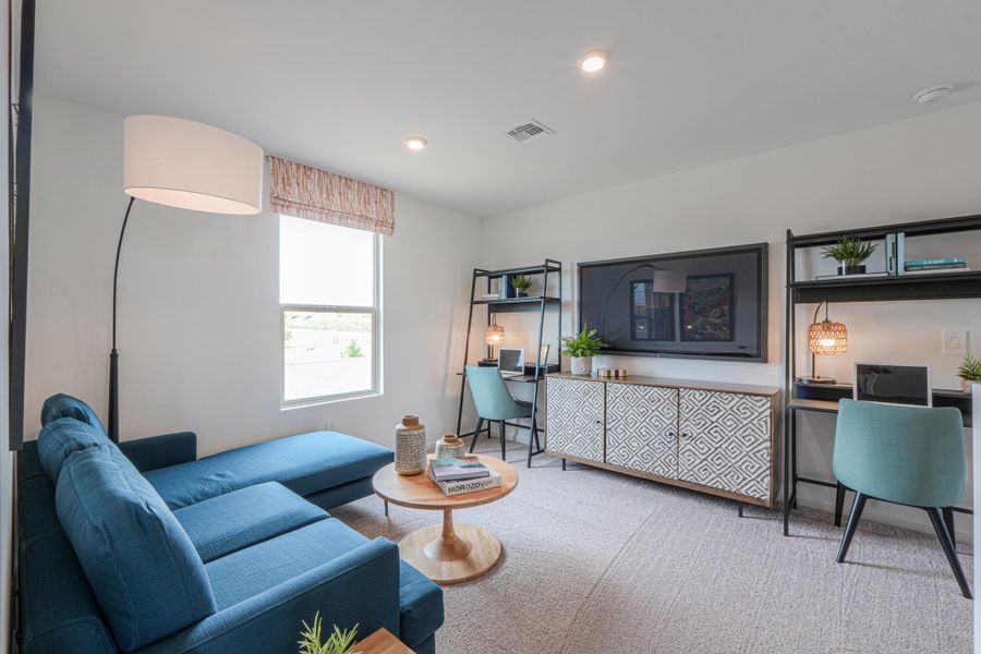 A living room with blue couches. A living room with blue couches.