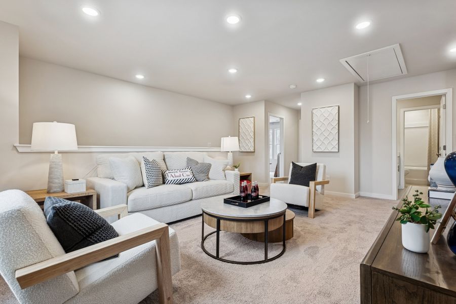 A living room with a couch and a coffee table. A living room with a couch and a coffee table.
