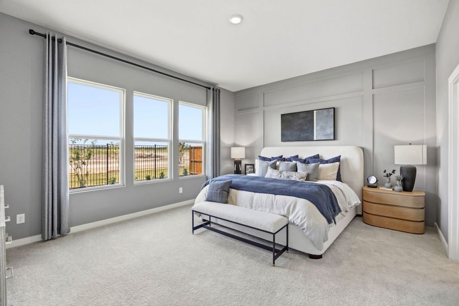 A bedroom with a bed and a bench. A bedroom with a bed and a bench.