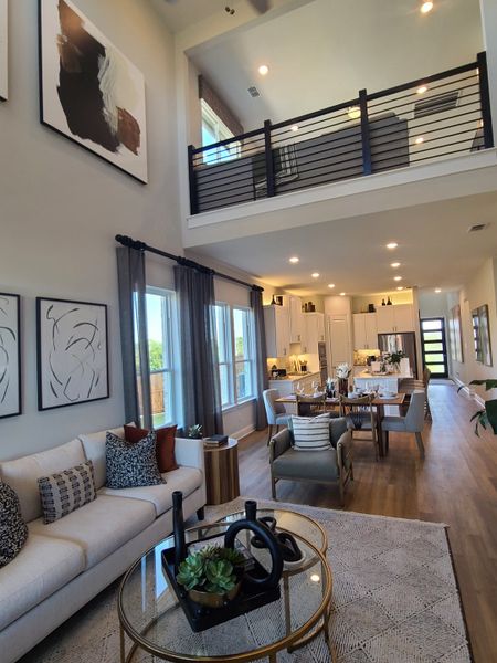 An elegant open-plan living area with modern decor, high ceilings, and stylish furnishings.