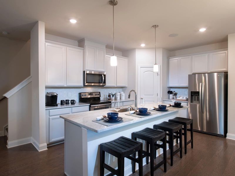The sprawling kitchen island overlooks the open-concept dining and living areas.