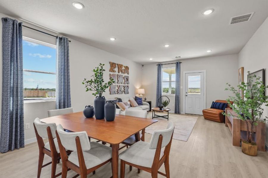 A dining room with a large window.