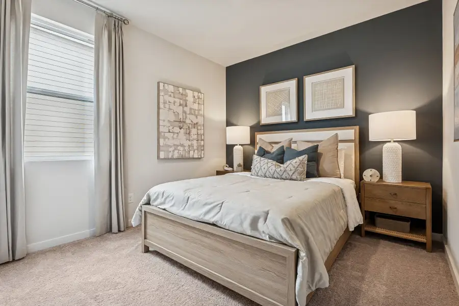 A bedroom with a bed and lamps. A bedroom with a bed and lamps.