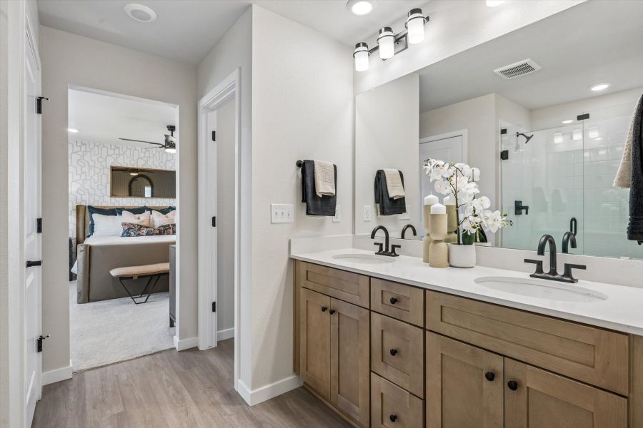 A bathroom with a large mirror. A bathroom with a large mirror.