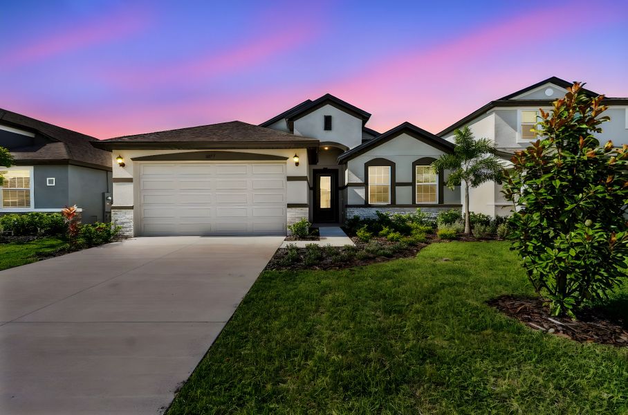 Front exterior of a home in the Tea Olive Terrace at the Fairways community, located in Palmetto, FL (Image 2).