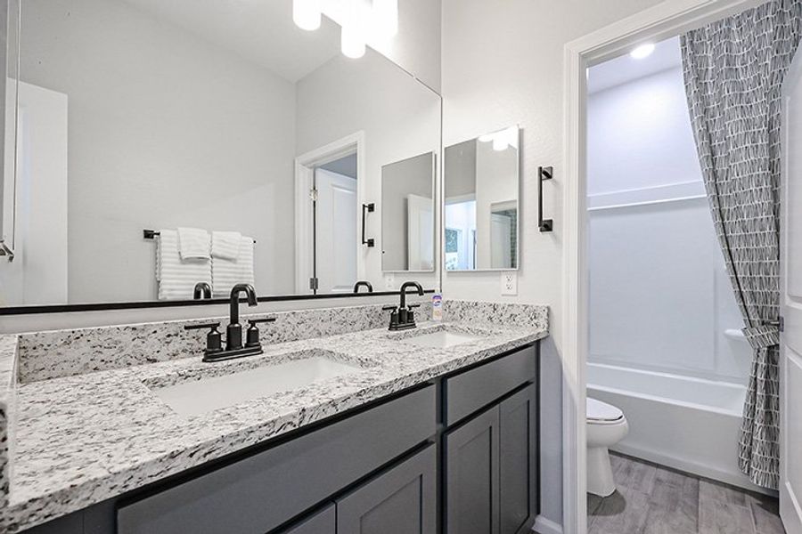 A bathroom with a marble countertop.