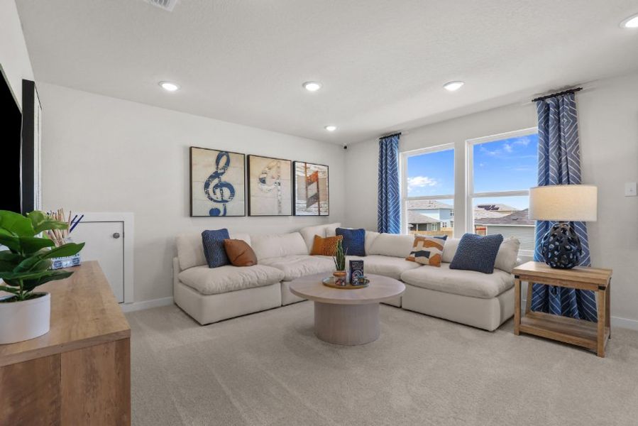 A living room with a white couch and a table.