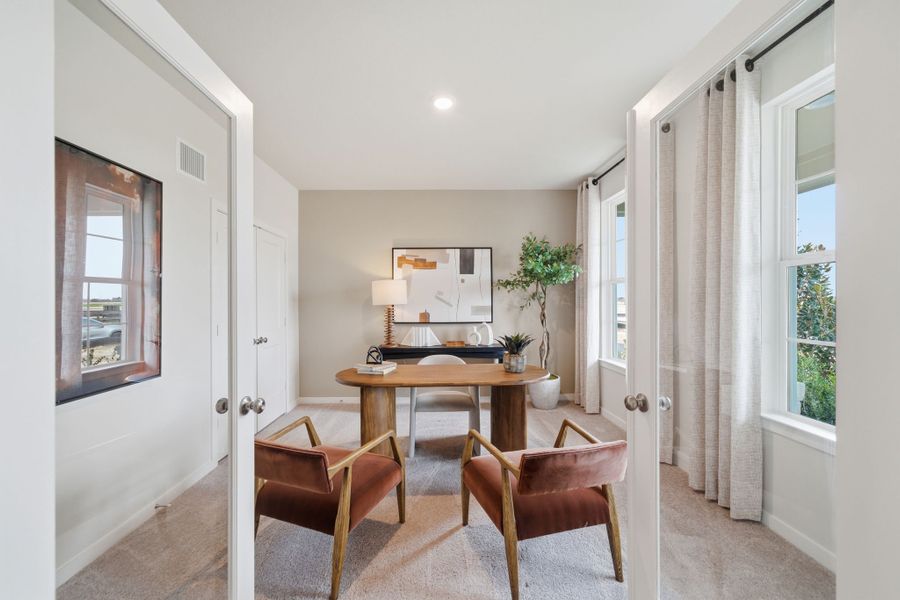 A room with a table and chairs.