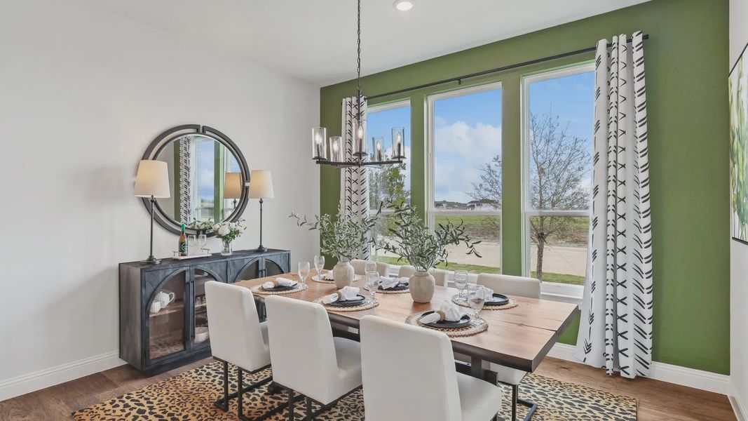 Experience refined elegance with a wood table, plush seating, and expansive windows in Green Meadows. Experience refined elegance with a wood table, plush seating, and expansive windows in Green Meadows.