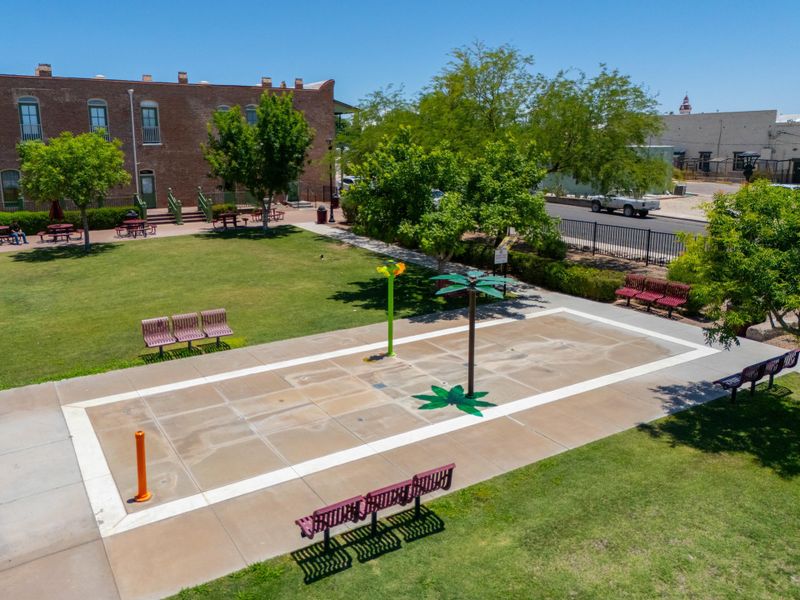 A courtyard with benches and trees.