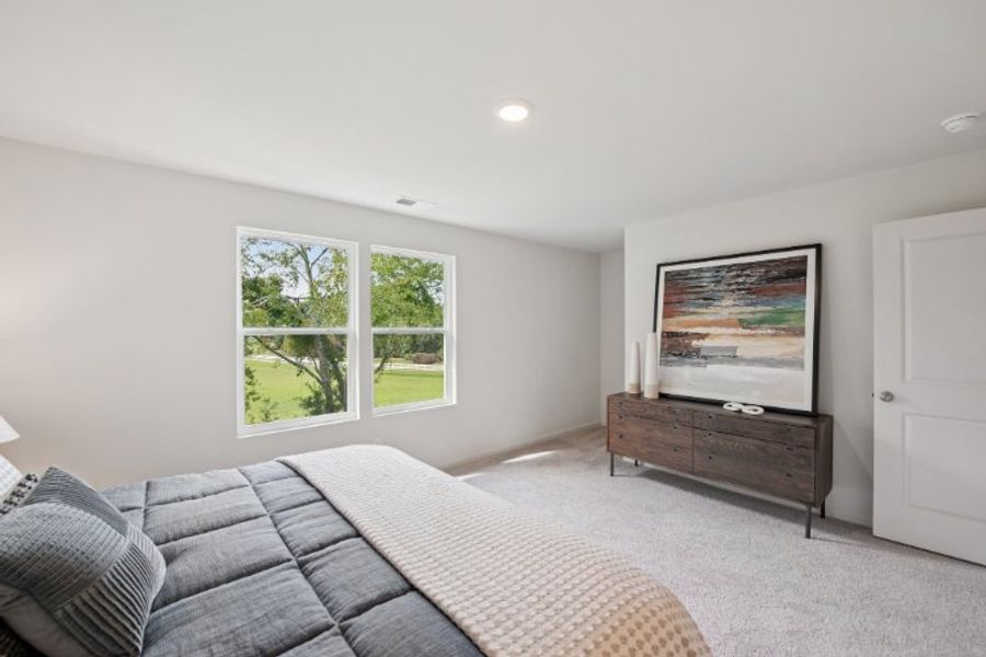 A room with a bed and a window.