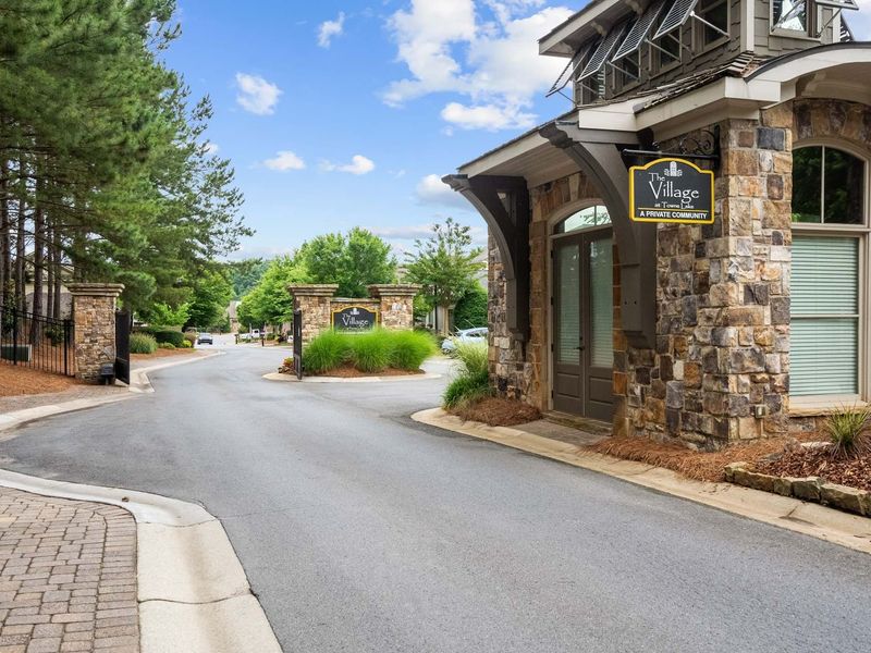 Entrance to the The Village at Towne Lake community in Woodstock, GA, featuring signage and landscaping (Image 17). Entrance to the The Village at Towne Lake community in Woodstock, GA, featuring signage and landscaping (Image 17).