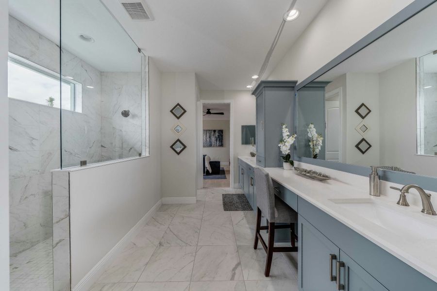 Master Bath | Lucida Model:Master bath split vanity with view of walk-in shower and large tile flooring