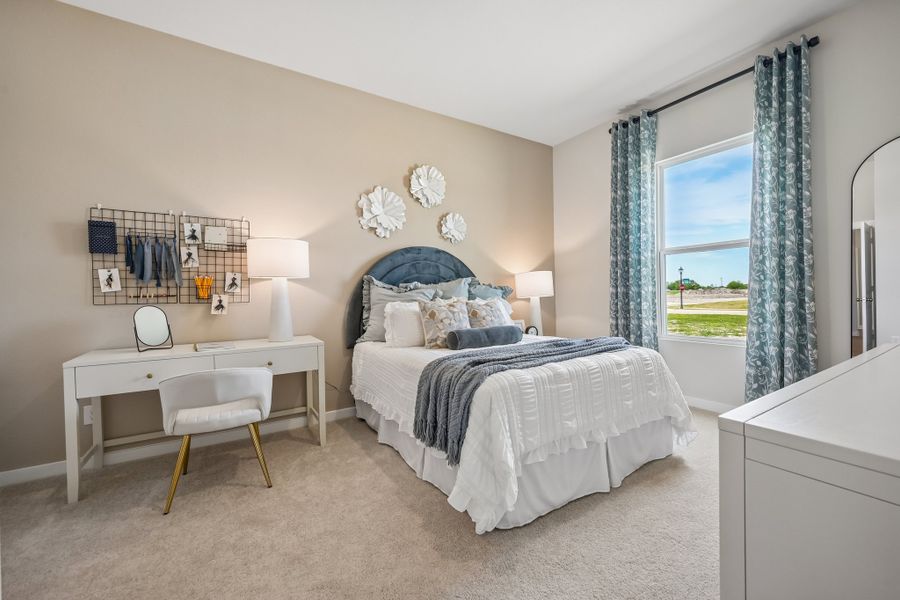 A bedroom with a bed and a table.