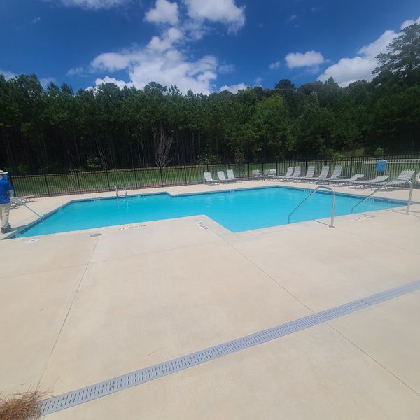 A pristine community pool surrounded by lush forest views in Sandtown Falls by Rockhaven Homes (Atlanta, GA). A pristine community pool surrounded by lush forest views in Sandtown Falls by Rockhaven Homes (Atlanta, GA).