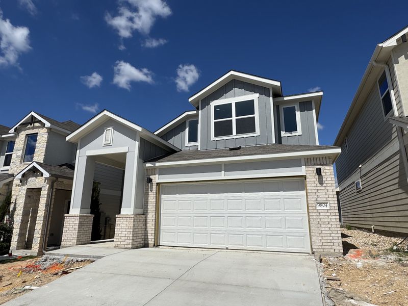 A modern two-story home with white brick and a spacious driveway in Messinger Village by Milestone Community Builders (Austin, TX). A modern two-story home with white brick and a spacious driveway in Messinger Village by Milestone Community Builders (Austin, TX).