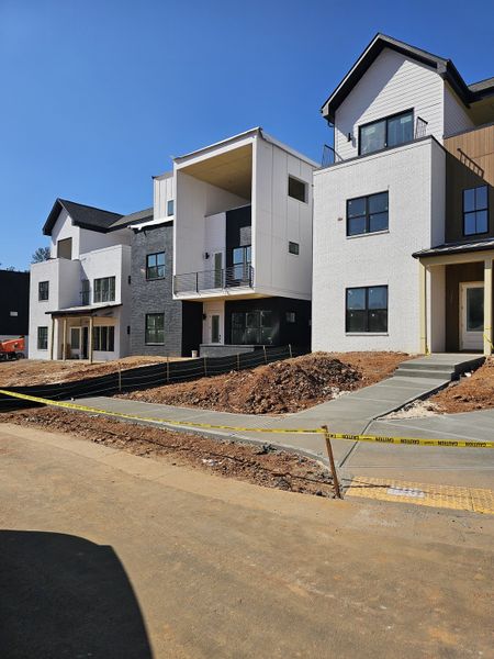 Modern multi-level homes with sleek facades in The Gathering – Alpharetta by Brock Built (Alpharetta, GA).
