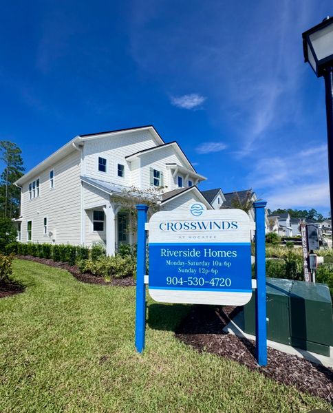 Charming white home with manicured lawn in the Crosswinds at Nocatee by Riverside Homes (Ponte Vedra Beach, FL).