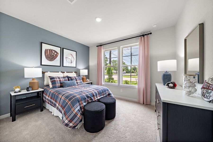 A bedroom with a bed and a mirror.