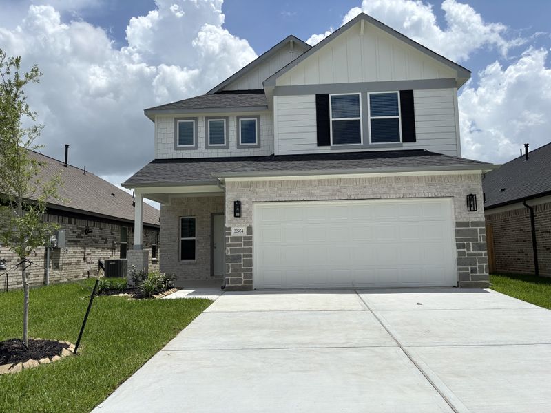 A charming modern home with white siding and a spacious yard in Breckenridge Park by Long Lake Ltd. (Spring, TX).