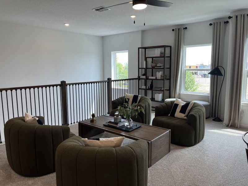 A cozy loft with green armchairs, a wooden coffee table, elegant shelving, and soft lighting from large windows. A cozy loft with green armchairs, a wooden coffee table, elegant shelving, and soft lighting from large windows.