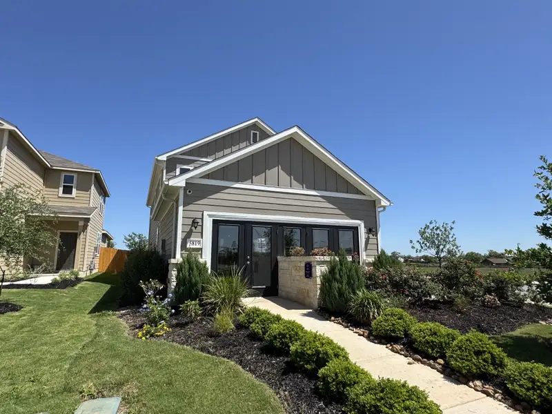 Charming gray home with landscaped garden in Blue Ridge Ranch by Century Communities (San Antonio, TX). Charming gray home with landscaped garden in Blue Ridge Ranch by Century Communities (San Antonio, TX).