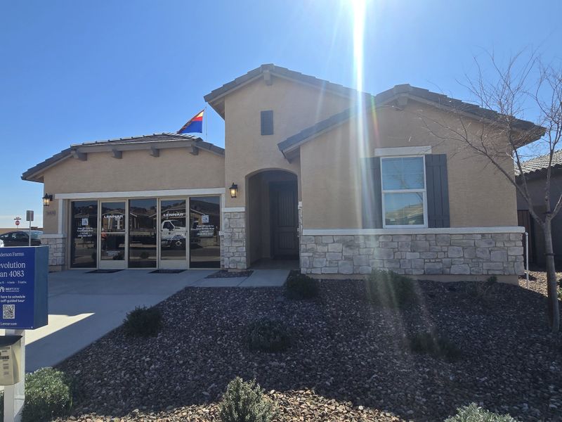 A beautiful stone-accented home with sunny landscaping in Anderson Farms: Premier by Lennar (Maricopa, AZ).