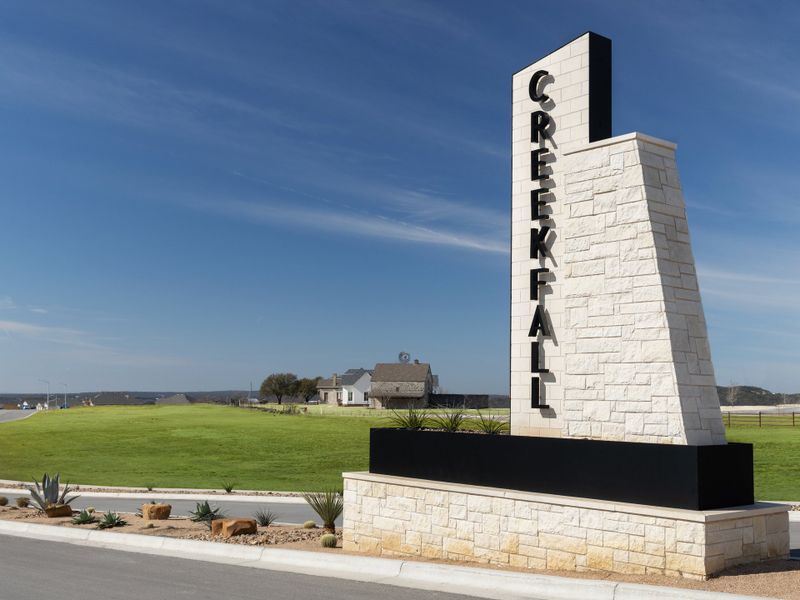 Entrance to the Creekfall community in Burnet, TX, featuring signage and landscaping (Image 1). Entrance to the Creekfall community in Burnet, TX, featuring signage and landscaping (Image 1).