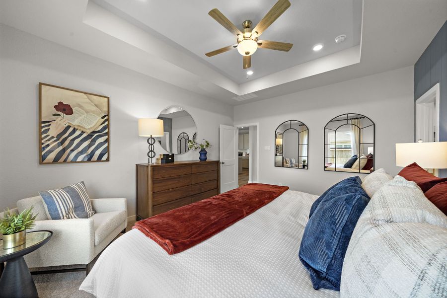 A bedroom with a bed and a couch.