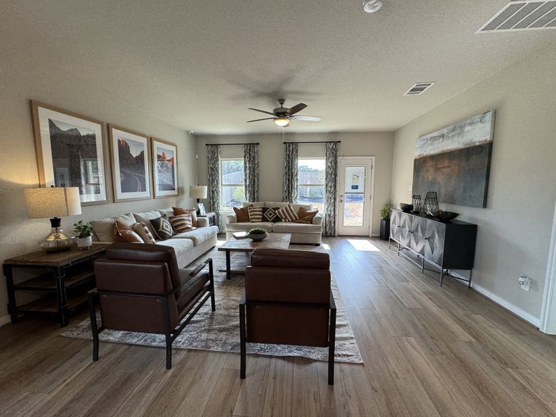 A cozy living room with plush seating, hardwood floors, and elegant art pieces, inviting relaxation.
