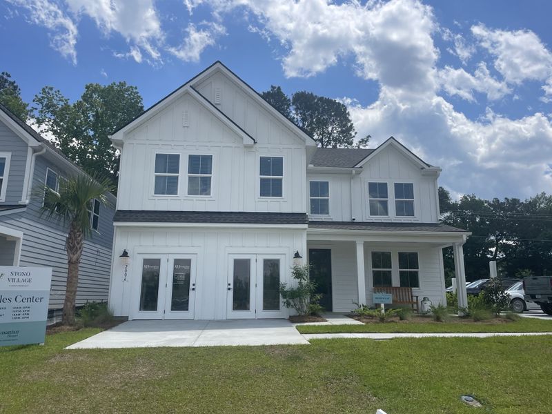 A charming white home with a welcoming front porch in Stono Village by K. Hovnanian® Homes (Hollywood, SC).
