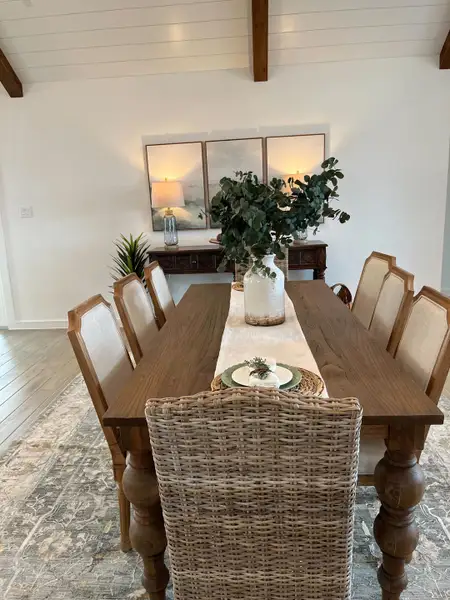 A charming dining room with a rustic wooden table, upholstered chairs, and elegant decor, creating a warm, inviting atmosphere.