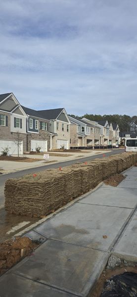 Newly built homes with brick and siding in The Enclave at Cooper Creek by Direct Residential Communities (Grayson, GA).