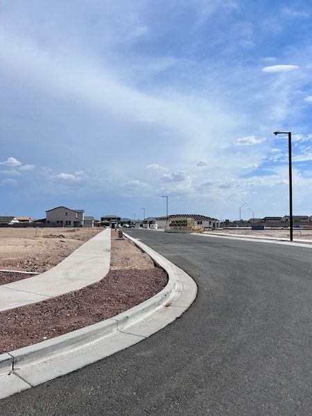 A developing neighborhood with new homes under construction in The Grove at El Cidro by William Ryan Homes (Goodyear, AZ).
