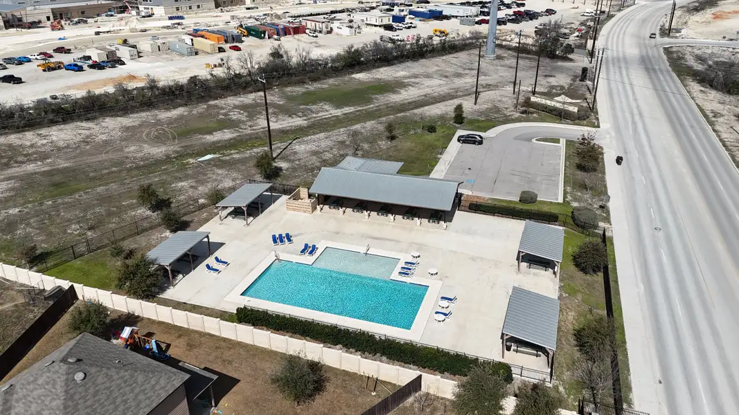 A modern community pool with sun loungers and shaded areas in Hunters Ranch by Chesmar Homes (San Antonio, TX). A modern community pool with sun loungers and shaded areas in Hunters Ranch by Chesmar Homes (San Antonio, TX).
