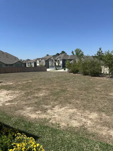 Wide open lot with nearby homes under clear blue skies in Woodforest by Chesmar Homes, Montgomery, TX. Wide open lot with nearby homes under clear blue skies in Woodforest by Chesmar Homes, Montgomery, TX.