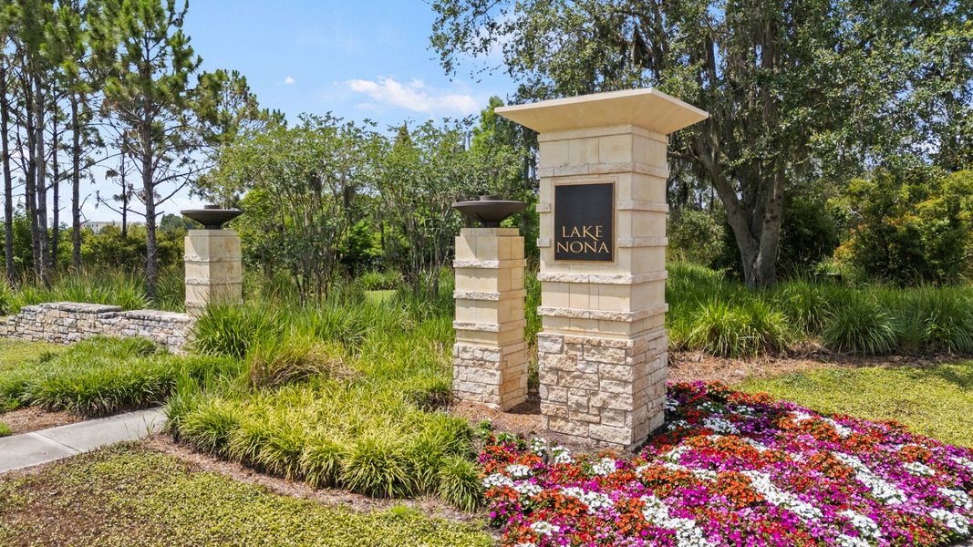 Lake Nona entrance sign in Orlando, FL, surrounded by colorful flowers and lush landscaping near DRB Homes Cyrene at Harmony Lake Nona entrance sign in Orlando, FL, surrounded by colorful flowers and lush landscaping near DRB Homes Cyrene at Harmony