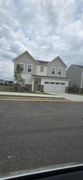 A charming two-story home with a modern facade and landscaped yard in Ashford Park by Starlight Homes (Covington, GA). A charming two-story home with a modern facade and landscaped yard in Ashford Park by Starlight Homes (Covington, GA).
