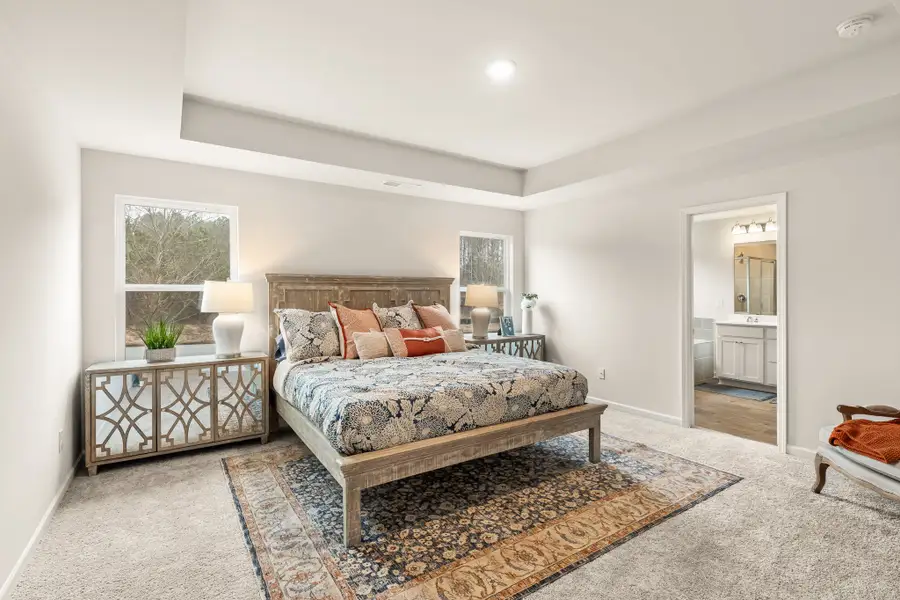 A bedroom with a bed and a table.