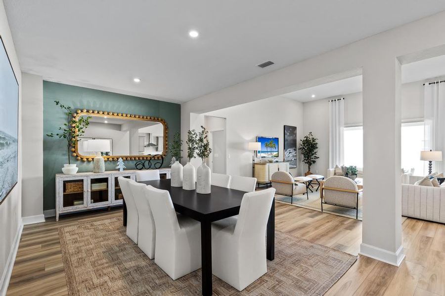 A large living room with a large mirror. A large living room with a large mirror.