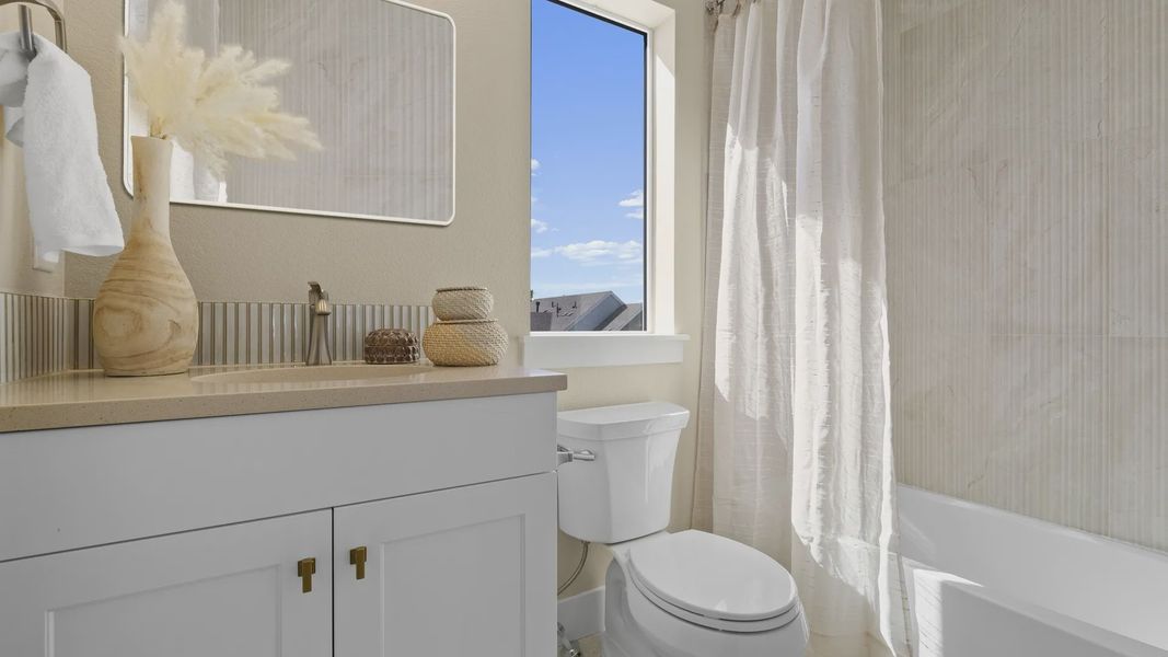 Elegant bathroom features upscale beige tiles, refined fixtures, and ample natural light in Dillon Pointe. Elegant bathroom features upscale beige tiles, refined fixtures, and ample natural light in Dillon Pointe.