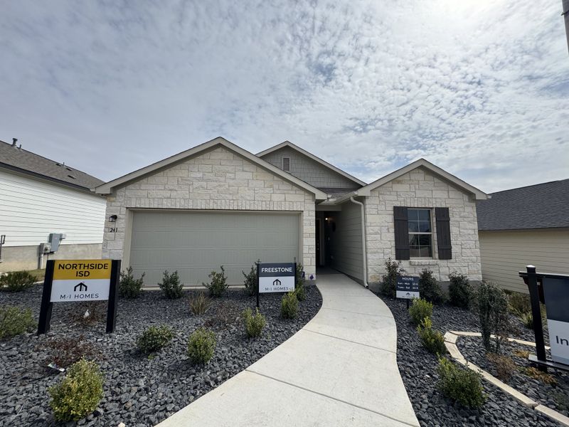 A charming stone facade home with landscaped entry in Hunters Ranch by M/I Homes, San Antonio, TX.