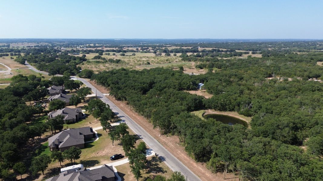 Aerial view of the Spring Valley Ranch community in Paradise, TX, showing layout and nearby surroundings (Image 1). Aerial view of the Spring Valley Ranch community in Paradise, TX, showing layout and nearby surroundings (Image 1).