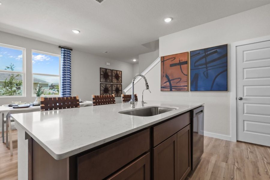 A kitchen with a sink and a table.