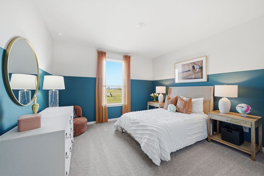 A bedroom with a bed and a mirror.