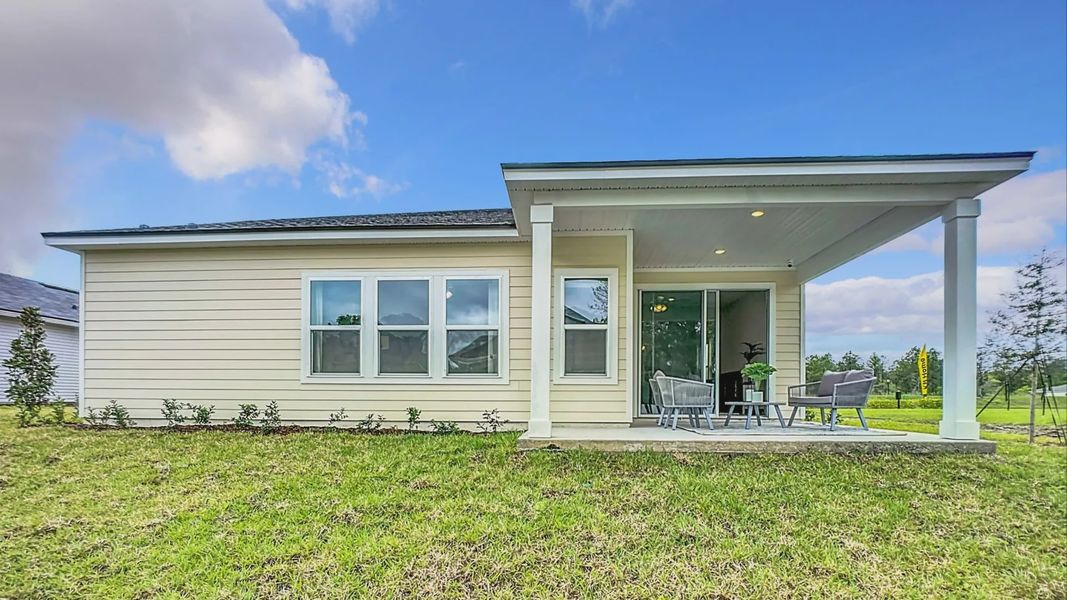 Elegant single-story residence in Panther Creek with sleek beige siding and an inviting covered patio.