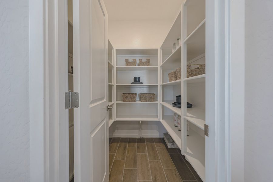 A white closet with shelves.