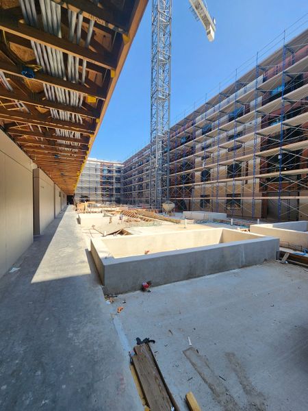 Construction site showing the foundations and scaffoldings in progress at Congress Lofts Saint Elmo by Intracorp (Austin, TX).
