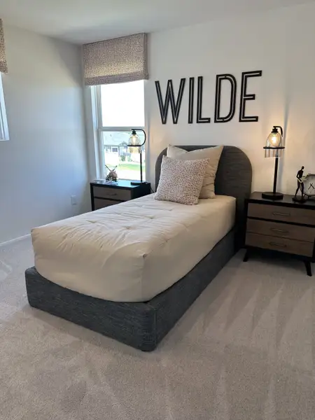 A cozy bedroom with a plush single bed, neutral decor, and stylish bedside lamps creating a serene atmosphere. A cozy bedroom with a plush single bed, neutral decor, and stylish bedside lamps creating a serene atmosphere.
