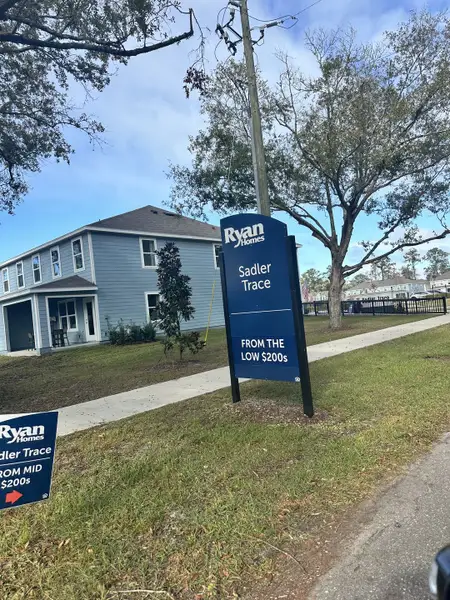 A charming two-story home with a blue exterior in Sadler Trace by Ryan Homes, Jacksonville, FL. A charming two-story home with a blue exterior in Sadler Trace by Ryan Homes, Jacksonville, FL.